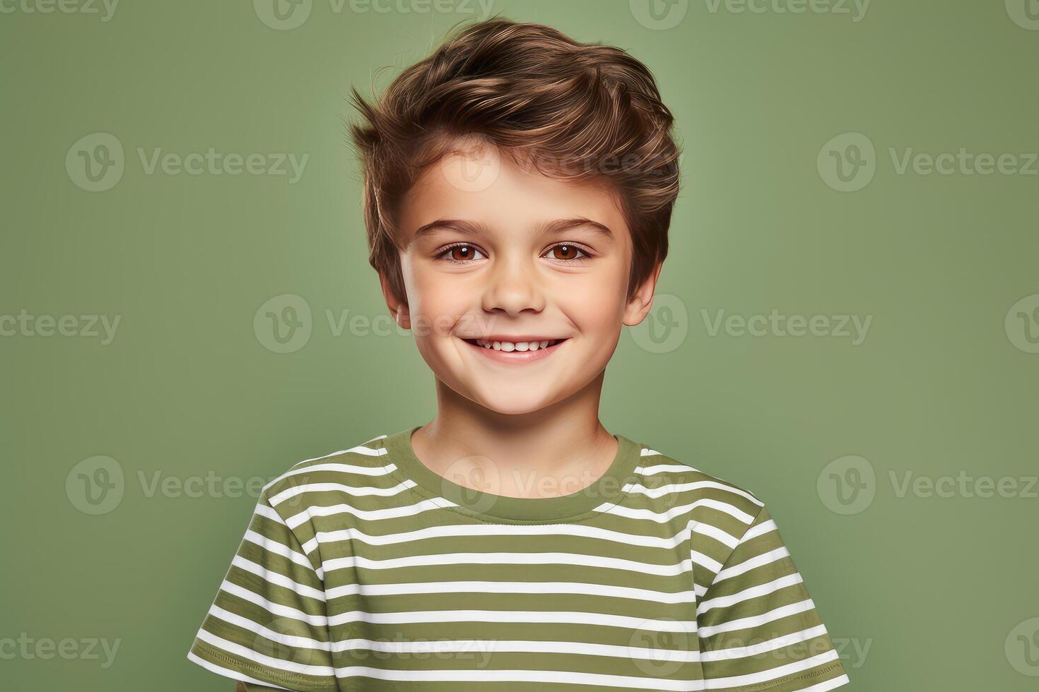 Portrait of smiling boy wearing striped t shirt on green background photo