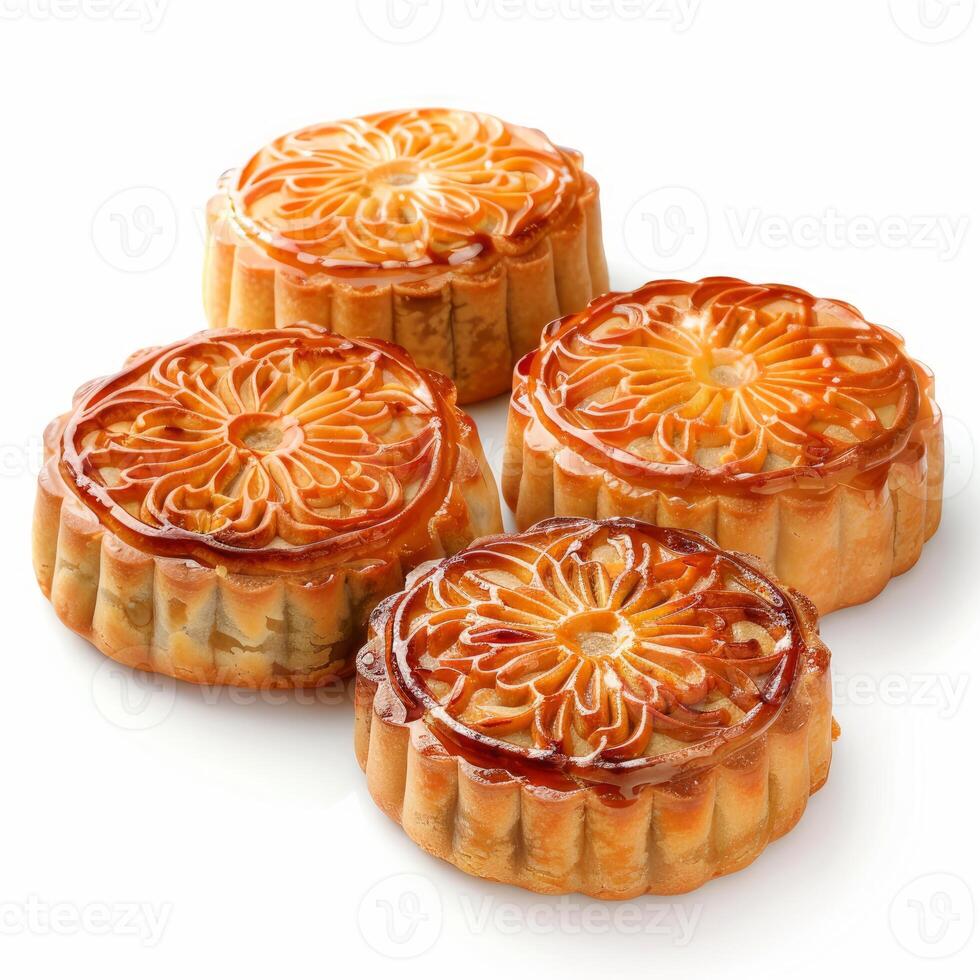Four delicious mooncakes showing intricate floral design resting on white background photo