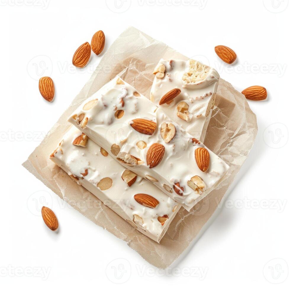 Delicious white chocolate bar with almonds resting on baking paper photo