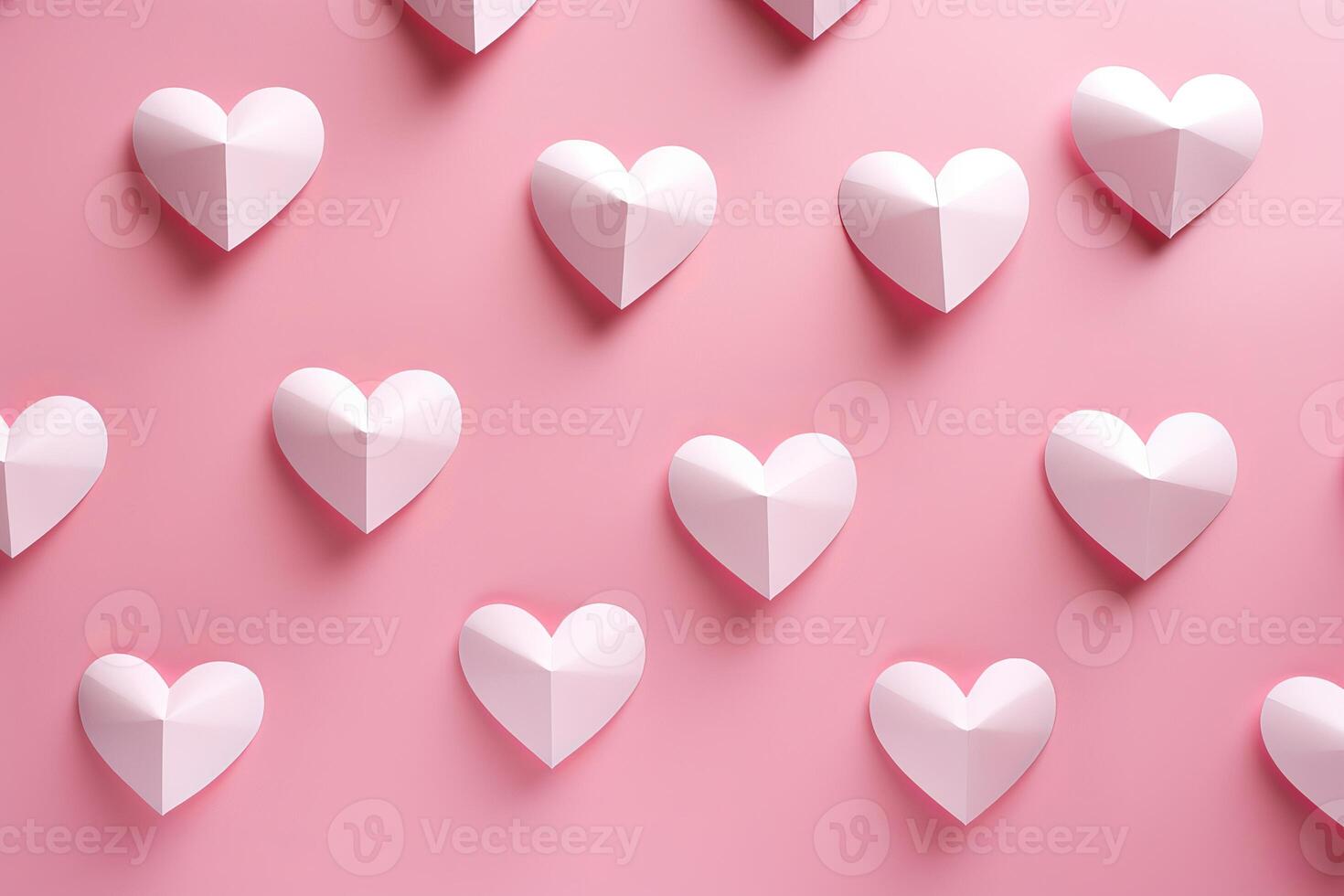 White paper hearts creating a romantic pattern on pink background photo