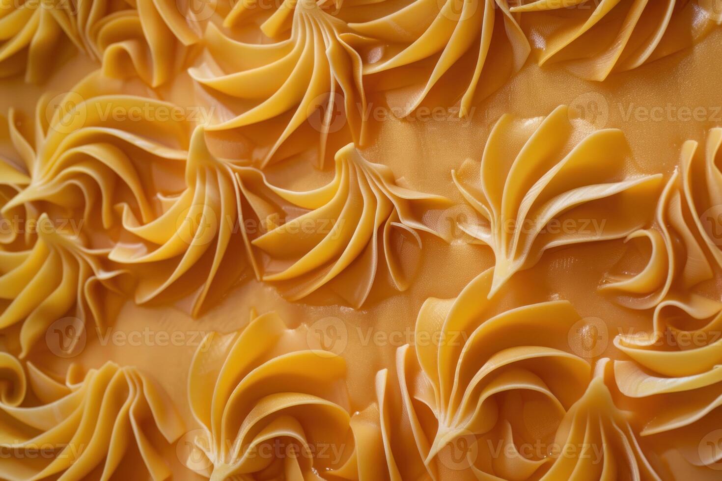 Creamy caramel frosting swirls adorn a cake, creating a visually appealing texture photo