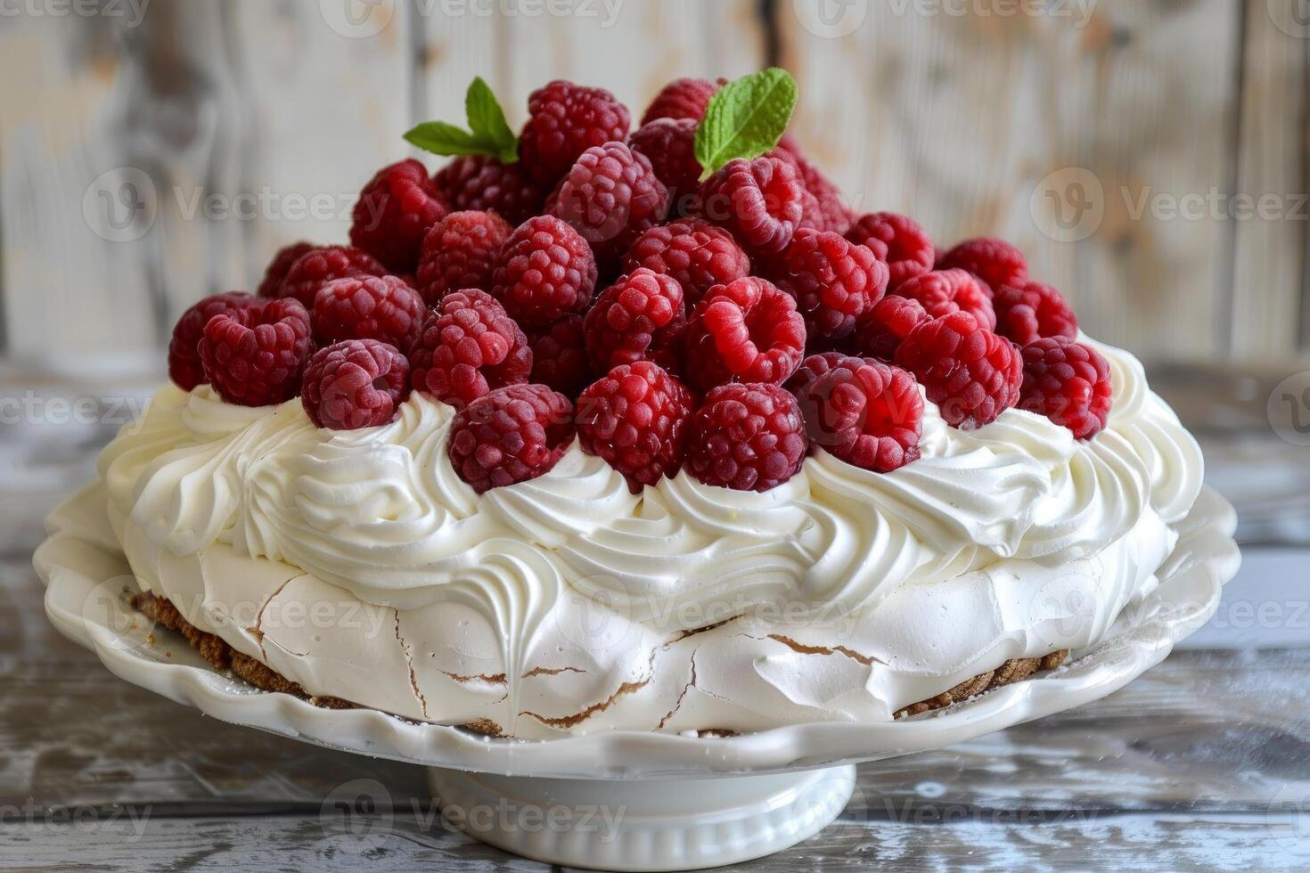 Delicious pavlova cake decorated with fresh raspberries and mint leaves photo