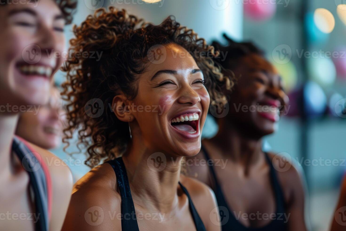 Group of diverse women laughing together after successful workout photo
