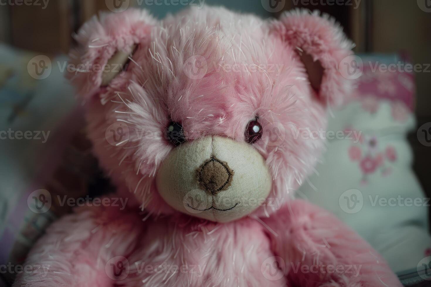 Pink fluffy teddy bear sitting on bed with pillows photo