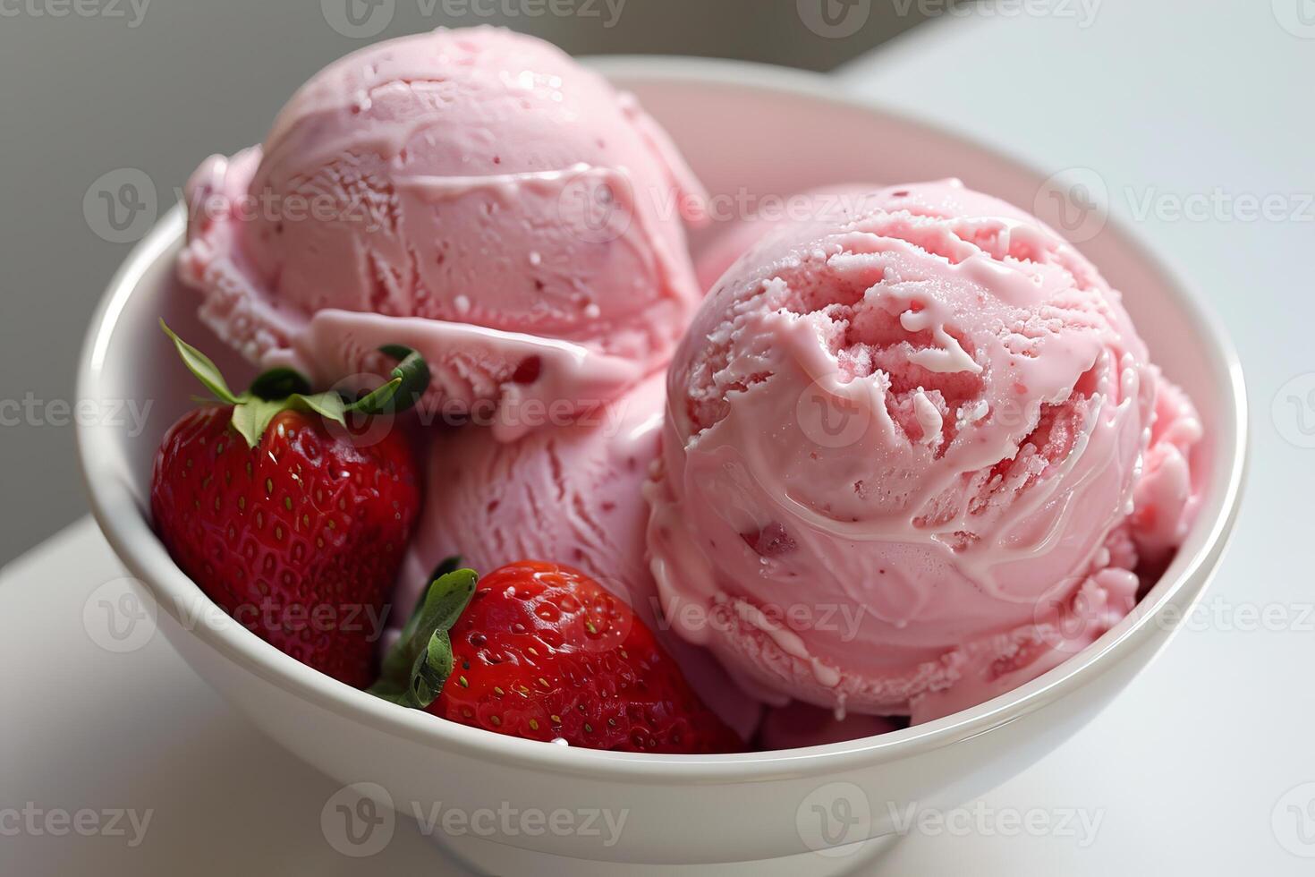 Strawberry ice cream scoops with fresh strawberries in a bowl photo