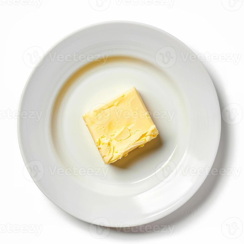 Single piece of butter resting on white plate, photo