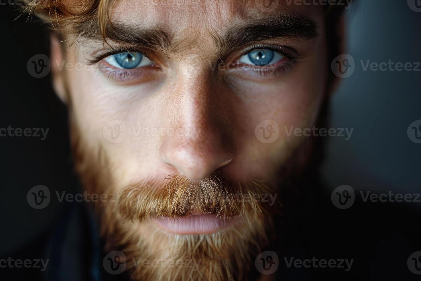 Portrait of ginger man showing intense blue eyes and reddish beard photo