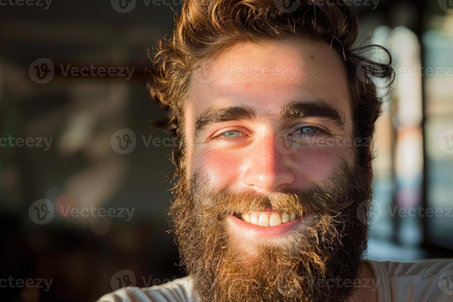 Portrait of smiling bearded man with blue eyes and brown hair photo