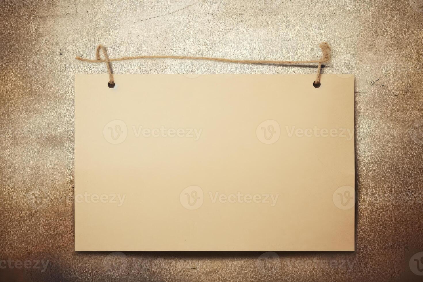 Blank sheet of paper hanging on a string against grunge background photo