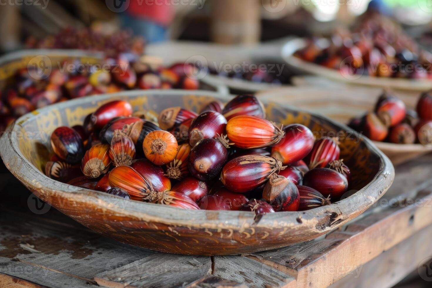 Freshly harvested palm oil fruits resting in wooden bowl photo