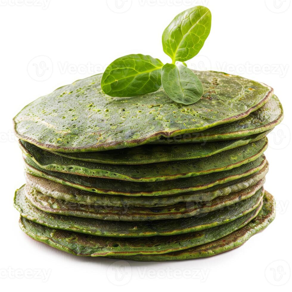 Stack of spinach pancakes garnished with fresh spinach leaves photo