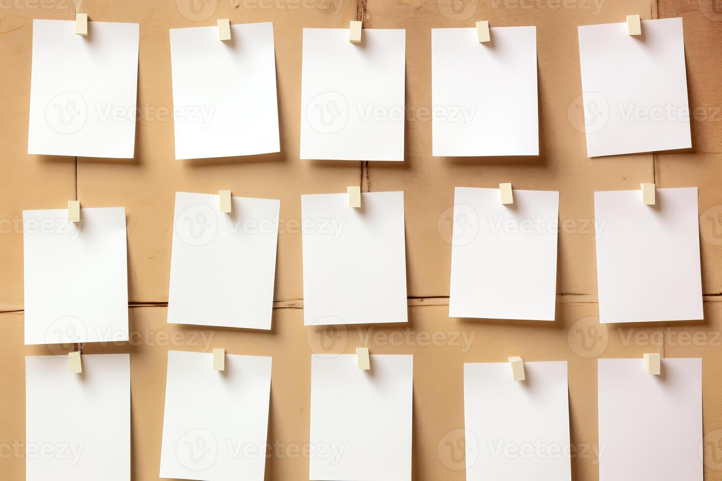 Fifteen blank papers hanging on a wooden board with clothespins photo