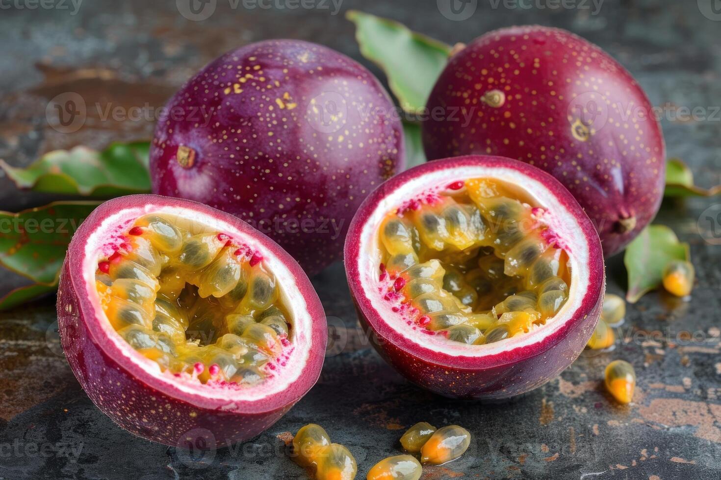 Fresh passion fruit showing juicy seeds and green leaves on rustic table photo