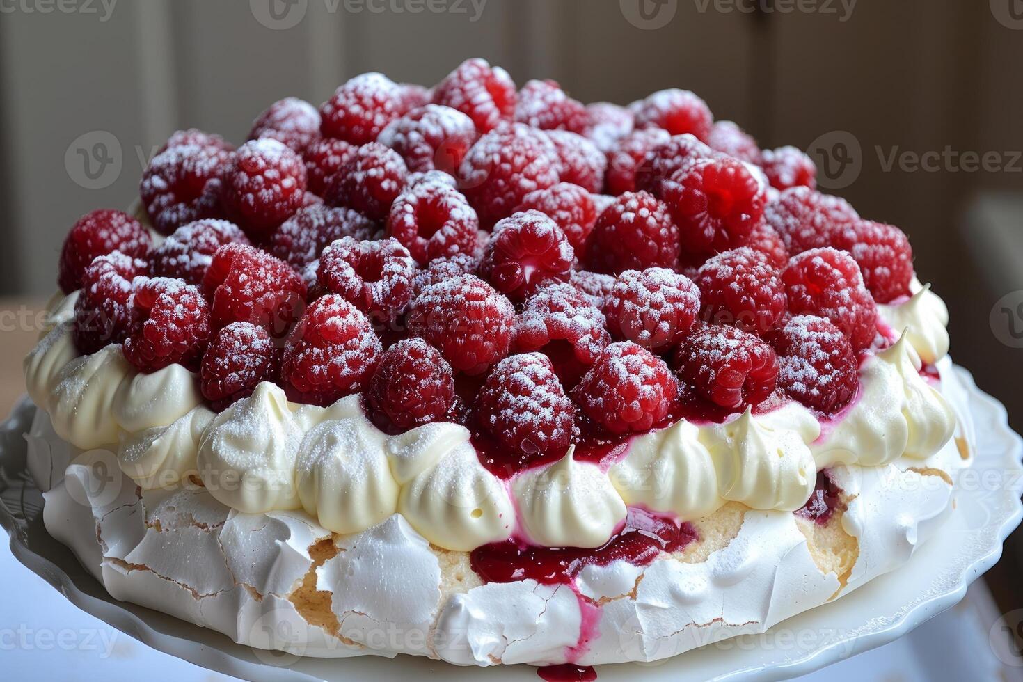 Delicious pavlova cake with fresh raspberries and whipped cream, sprinkled with icing sugar photo