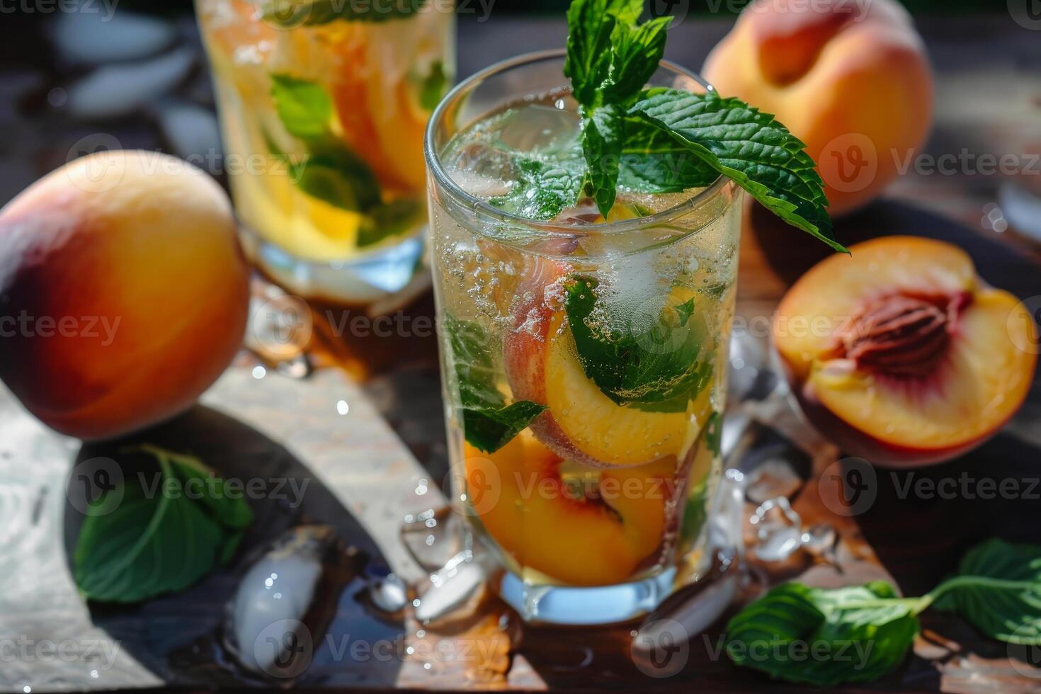 Refreshing peach iced tea with fresh mint and ice cubes on rustic wooden table photo