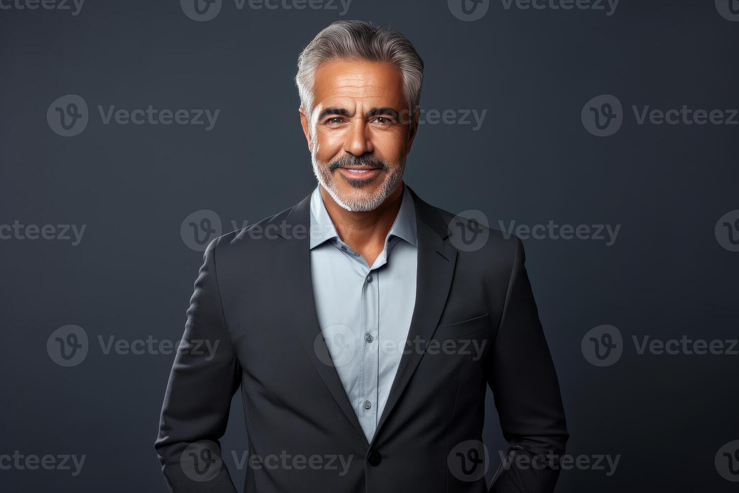 Smiling senior businessman wearing suit on dark background photo