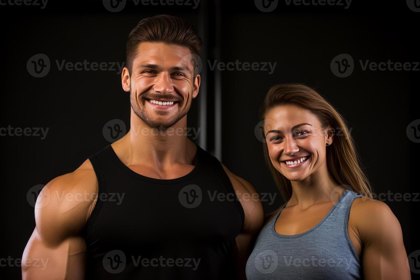 Happy muscular man and woman smiling after training session in gym photo