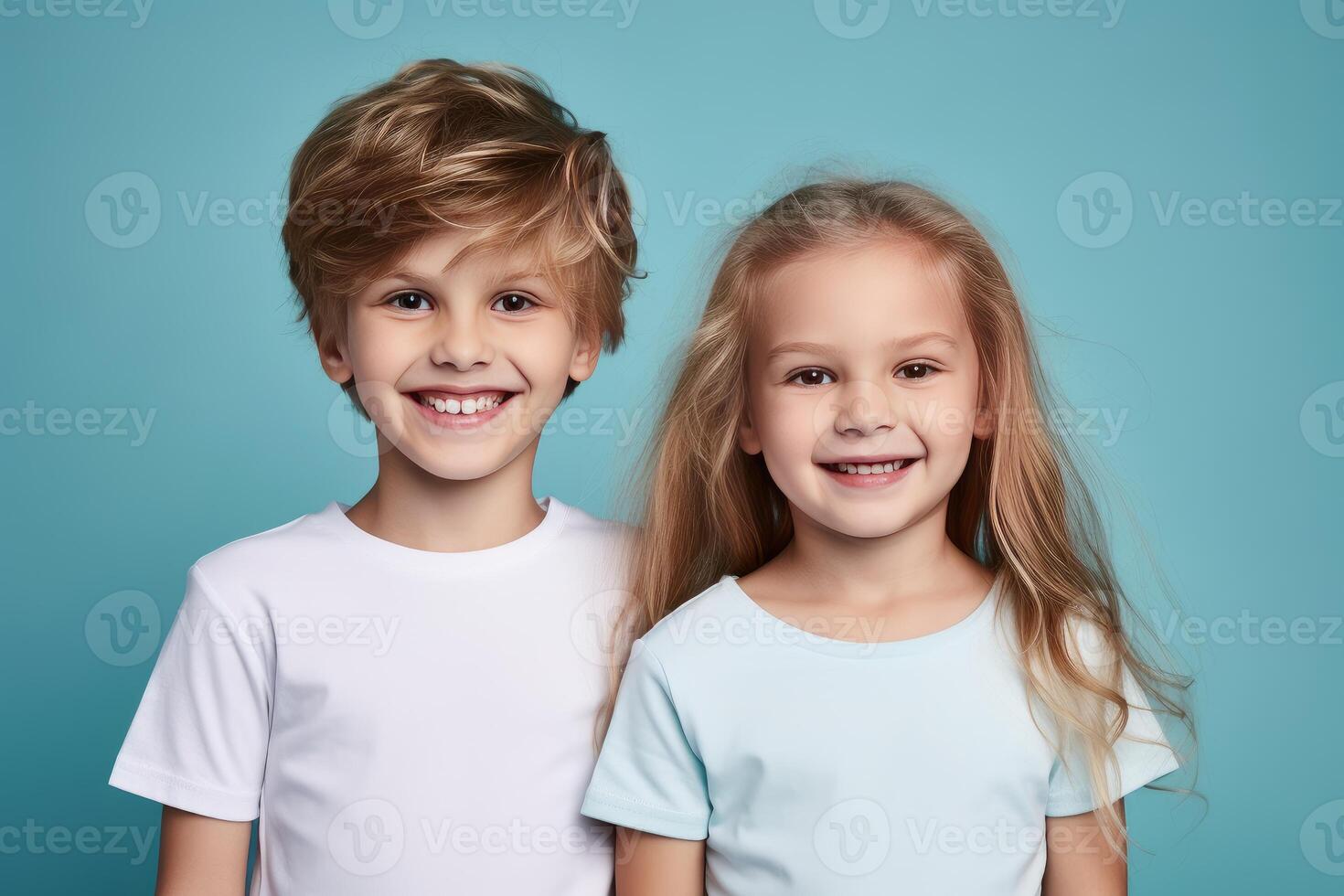Two happy smiling kids posing together on blue background photo