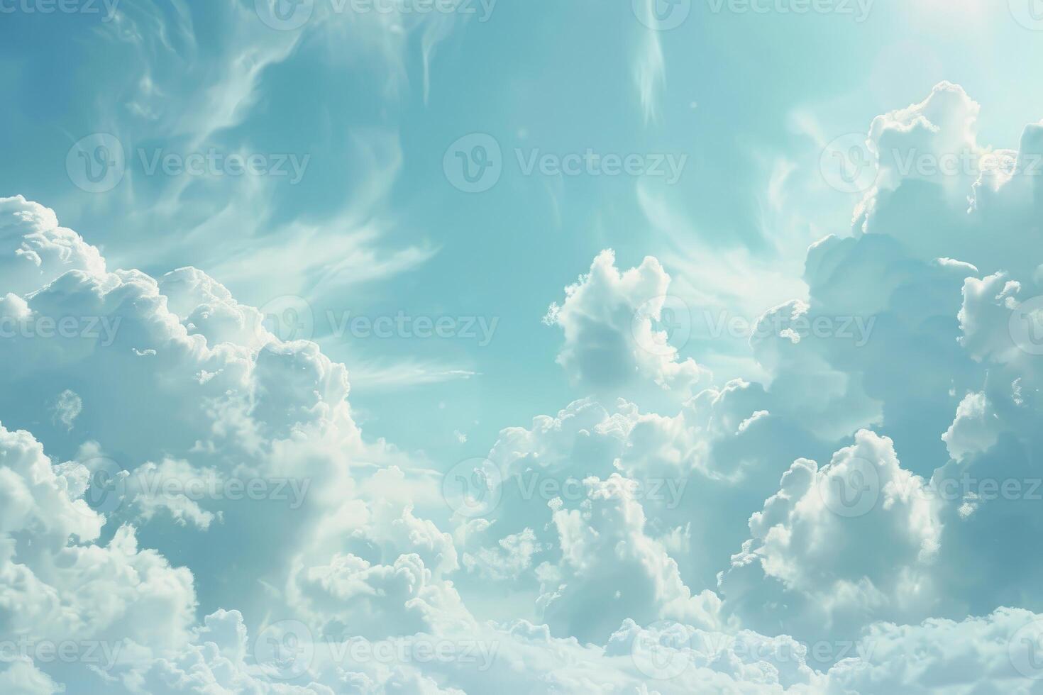 Bright sunlight shining through beautiful cumulus clouds in cyan sky photo