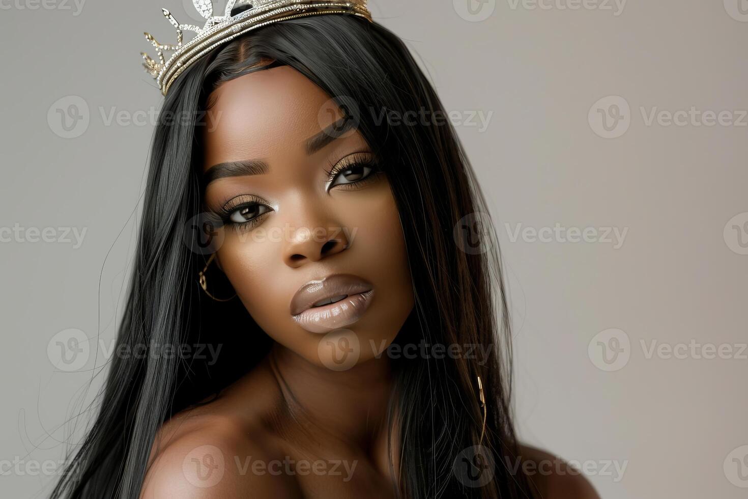 Beautiful black woman wearing crown posing in studio shot photo
