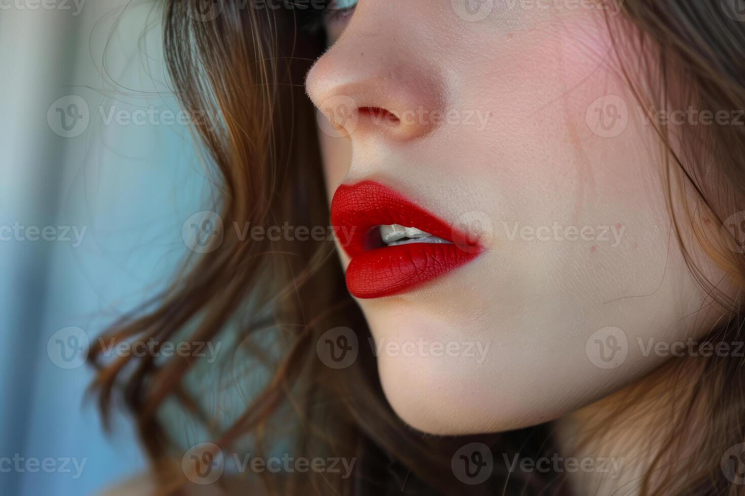 Close up of woman's face showing bright red lipstick and long brown hair photo