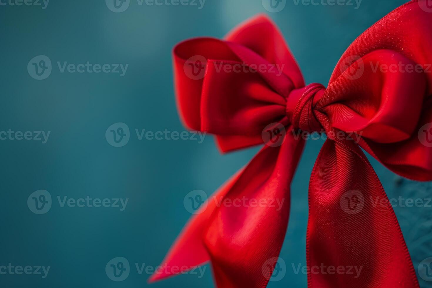 Elegant red bow enhancing a teal background for celebrations photo