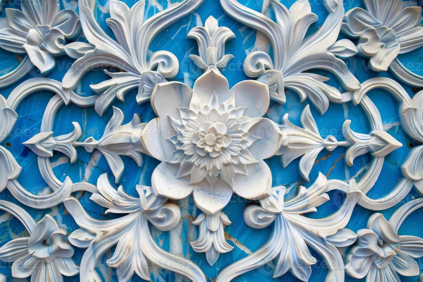 White floral bas relief sculpture on turquoise background creating intricate pattern photo