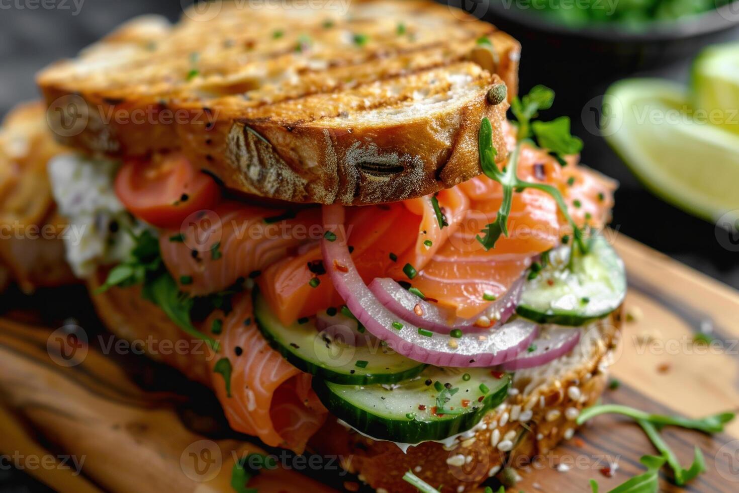 Delicious smoked salmon sandwich with cream cheese, cucumber, tomato, and red onion on toasted bread photo