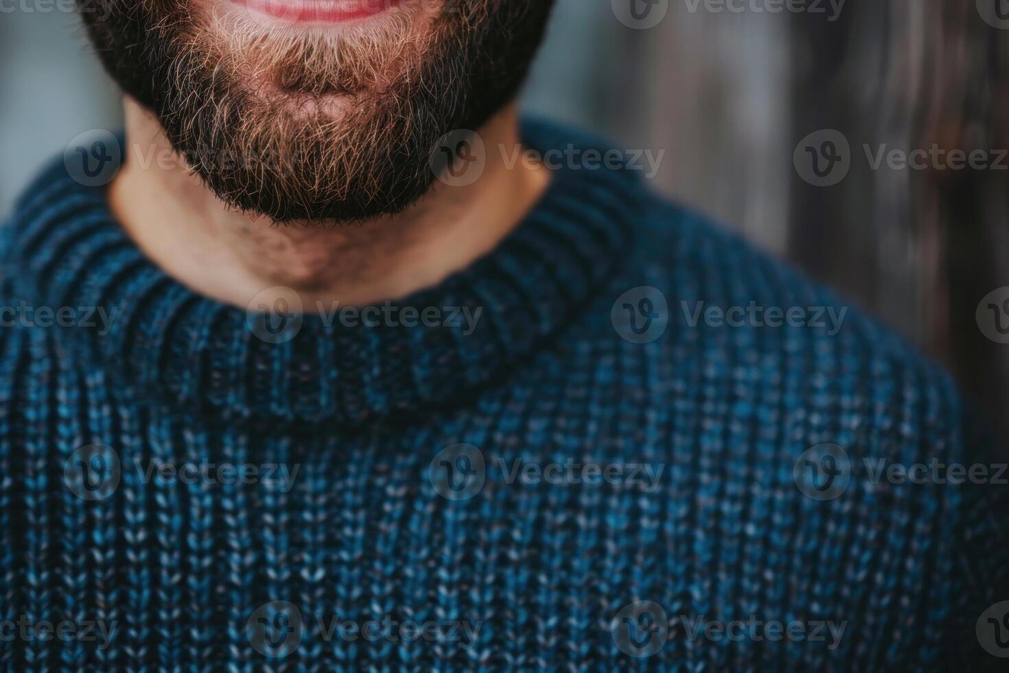 Smiling man wearing blue sweater and sporting brown beard photo
