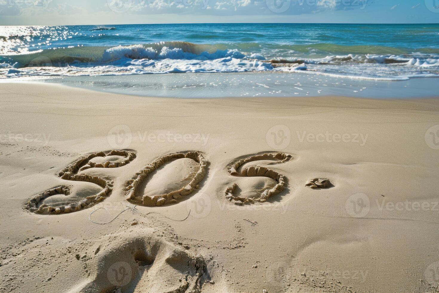 Sos message written on sandy beach by ocean waves photo