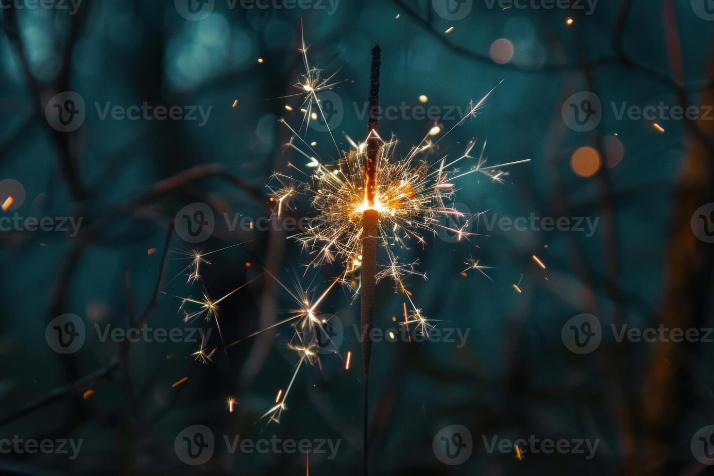 Bright sparkler burning with beautiful golden sparks in the dark photo