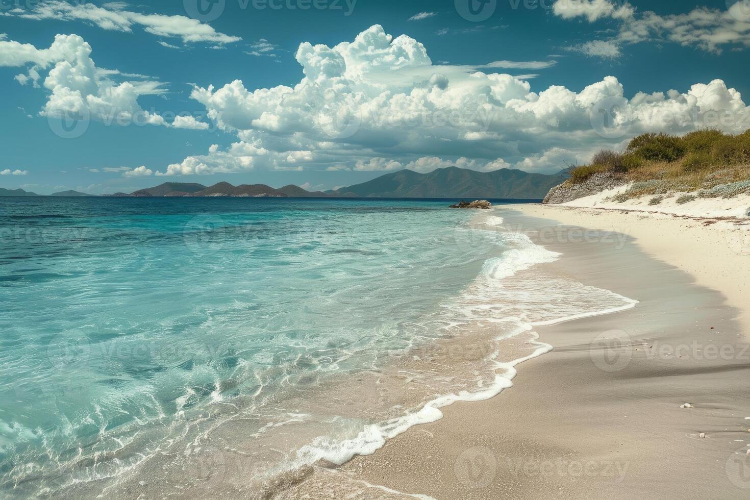 Pristine white sand beach meeting calm turquoise ocean under cumulus clouds in caribbean photo