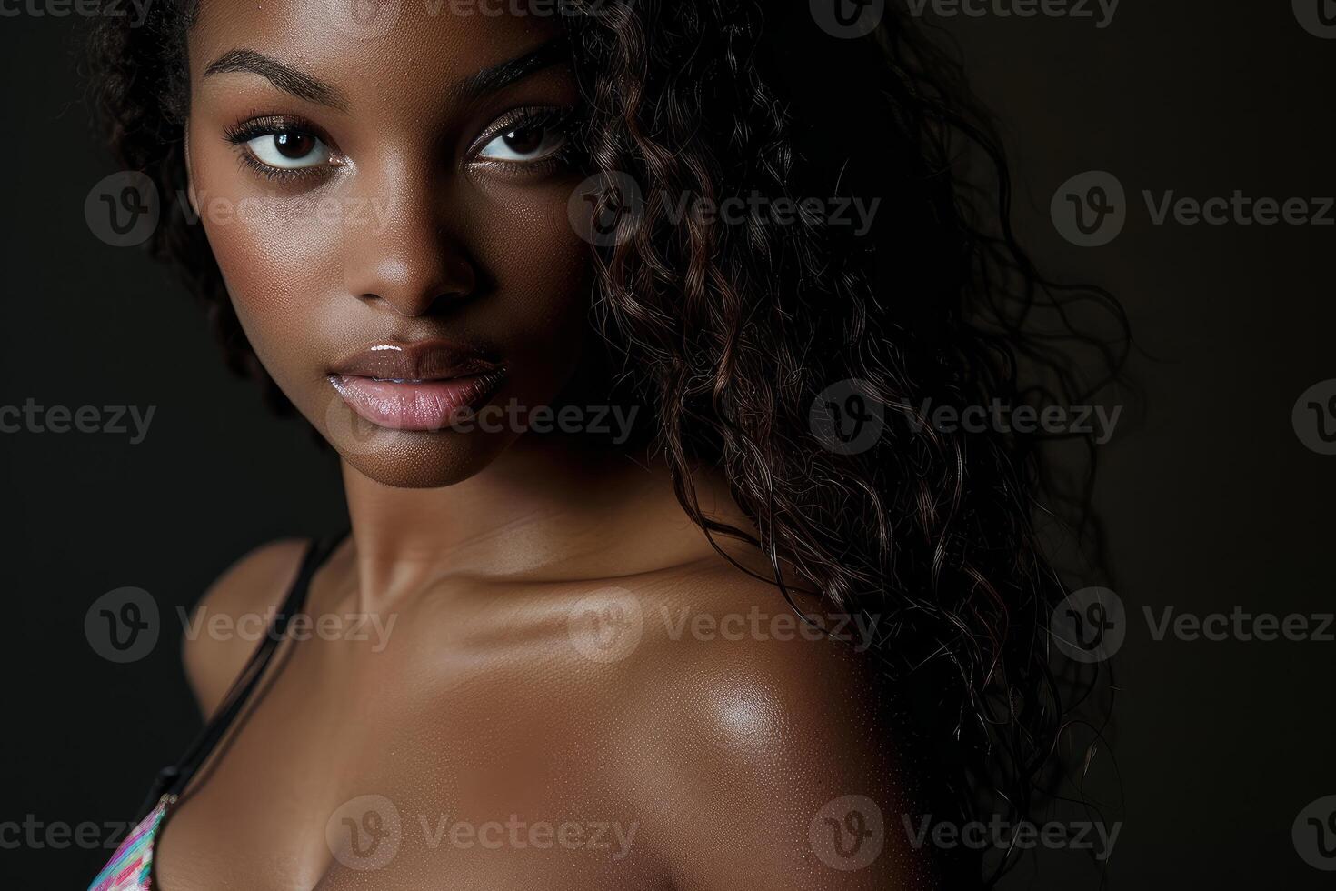 Beautiful black woman posing with long curly hair photo