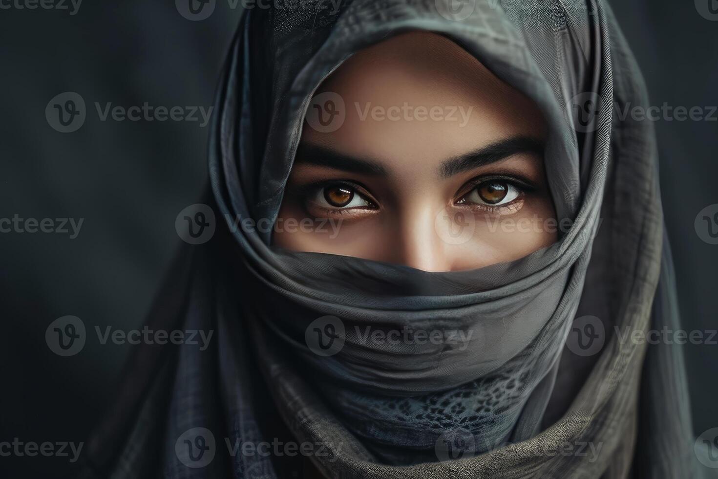 Muslim woman wearing traditional hijab covering face revealing expressive brown eyes photo