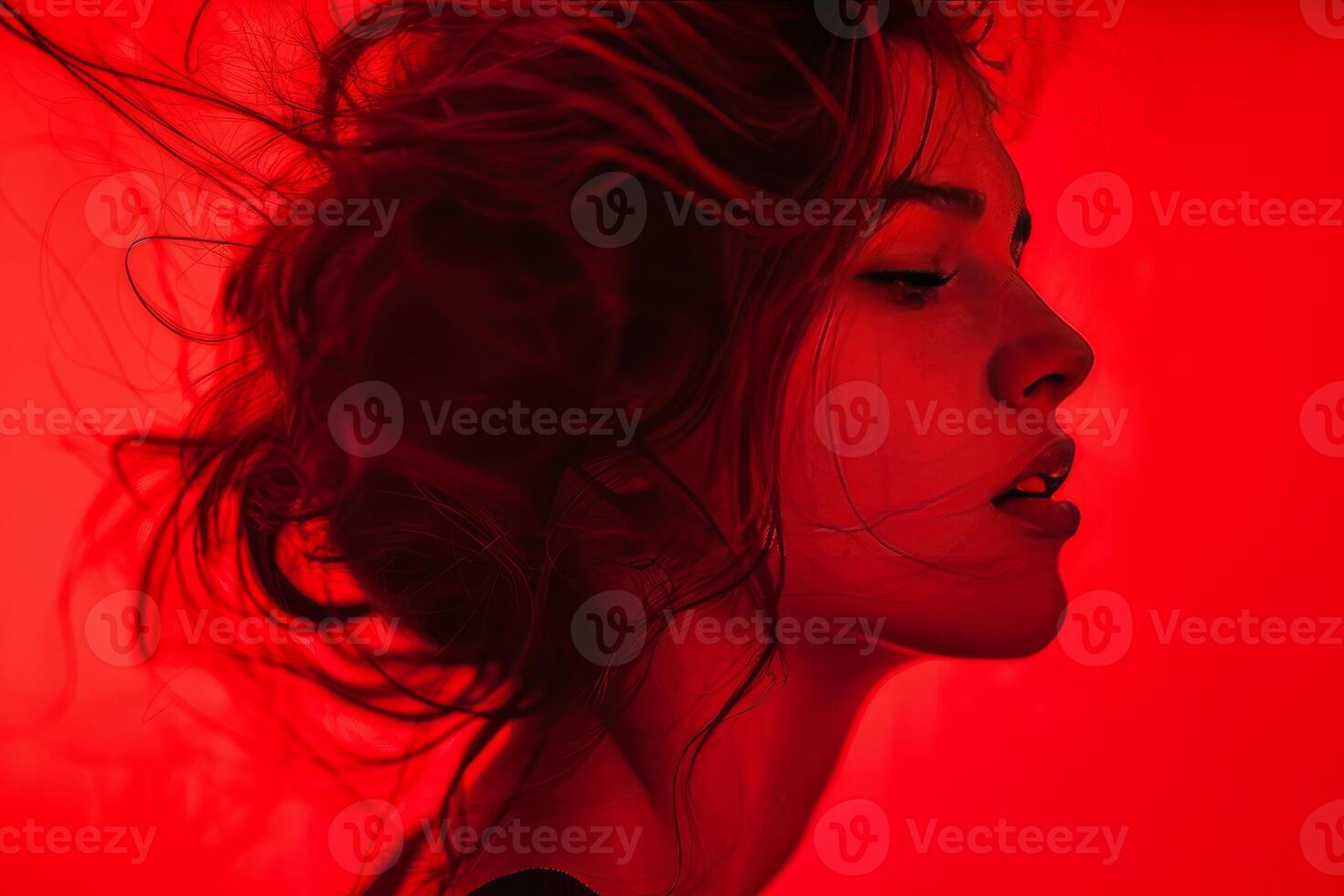 Model posing with red light and blowing hair photo