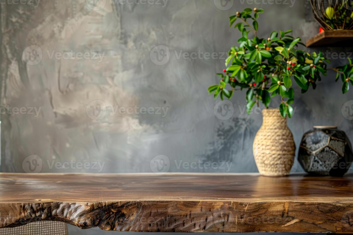 Empty wooden table presenting decorative plants and vases with blurred cement wall background photo