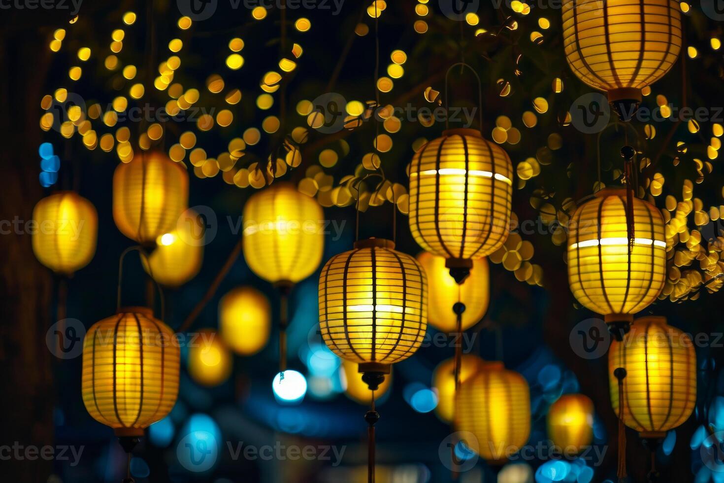 Glowing lanterns hanging at night creating a festive atmosphere photo