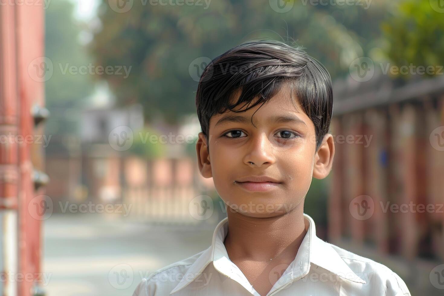 Young indian student wearing uniform posing outdoors photo