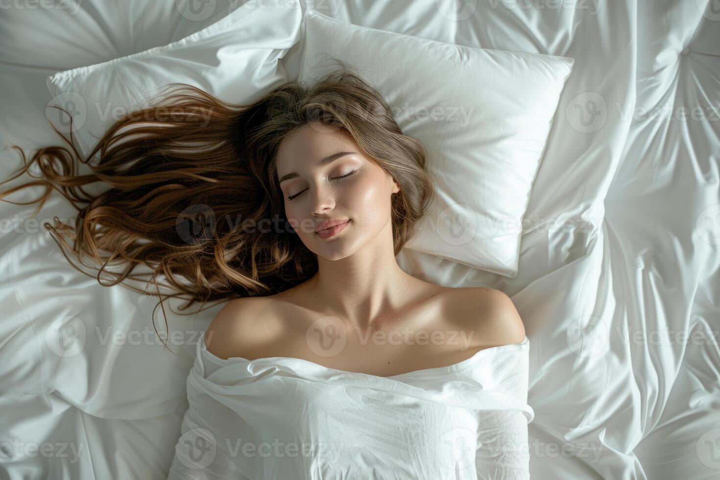 Beautiful woman sleeping peacefully in white comfortable bed photo
