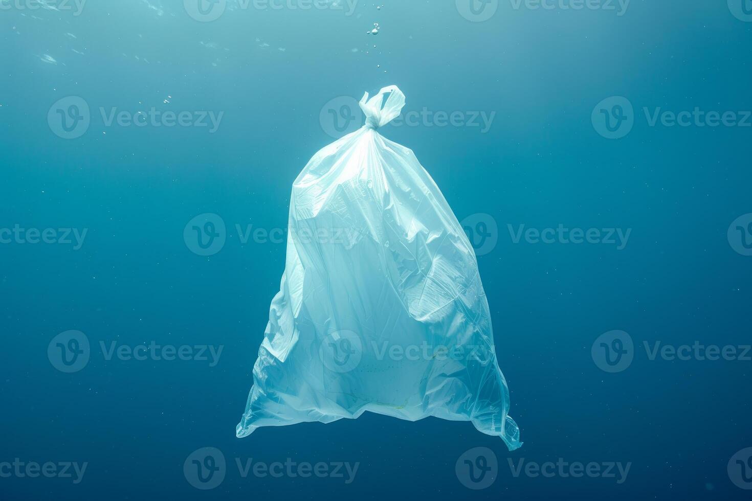A plastic bag floating in the ocean photo