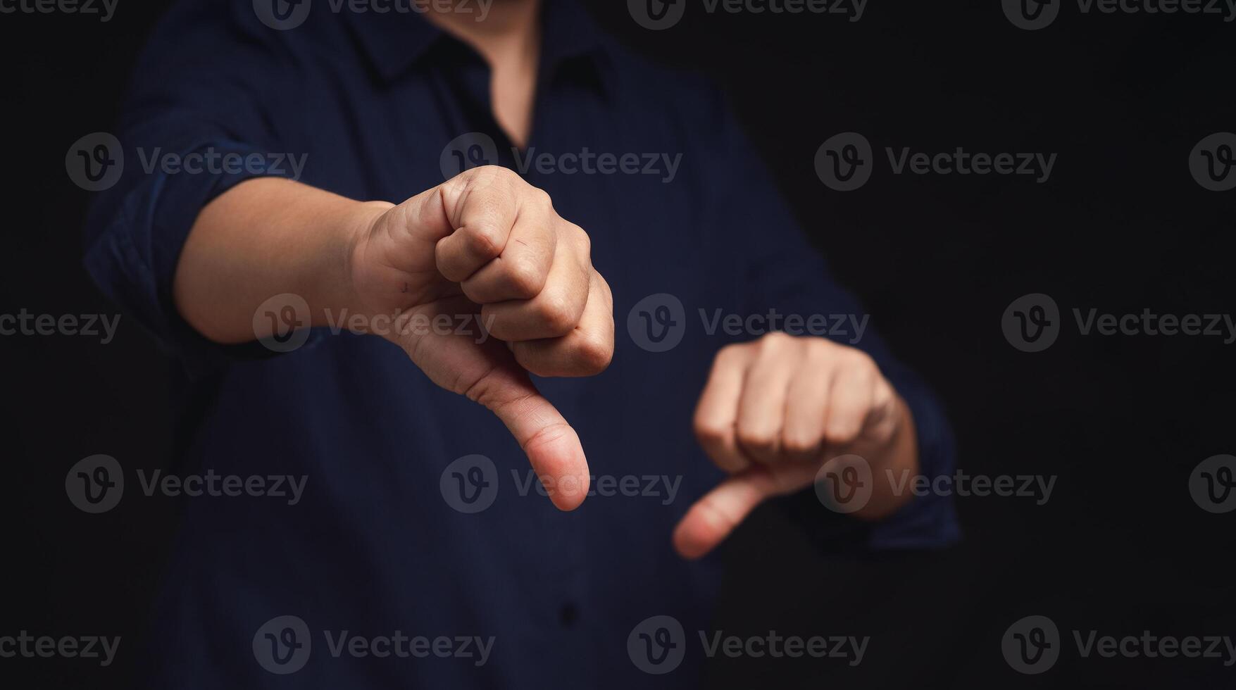 Negative concept. Close-up of businessman's hands showing a thumbs down for dislike service photo