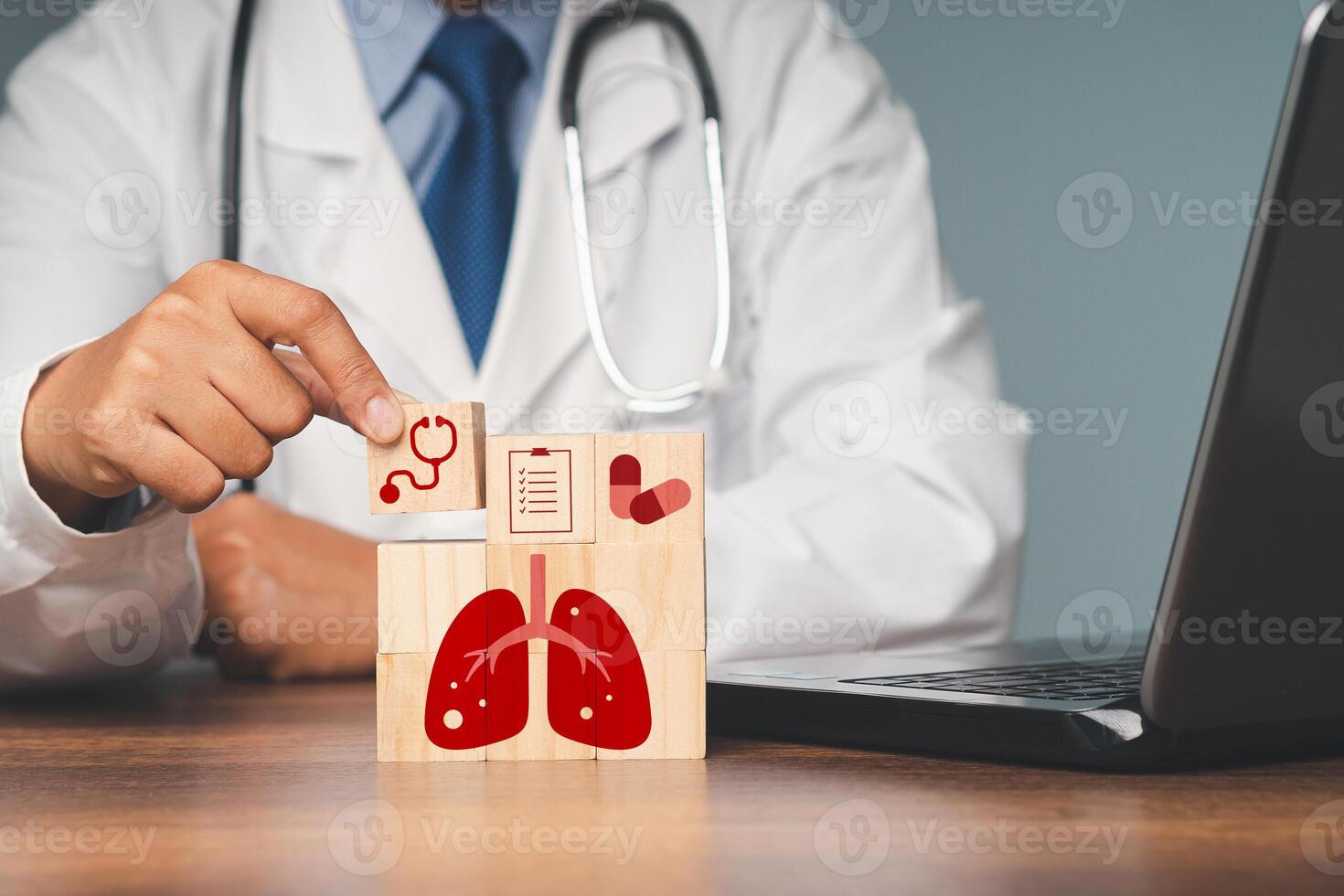 Close-up of a doctor is holding a wooden cube while sitting in the hospital. photo