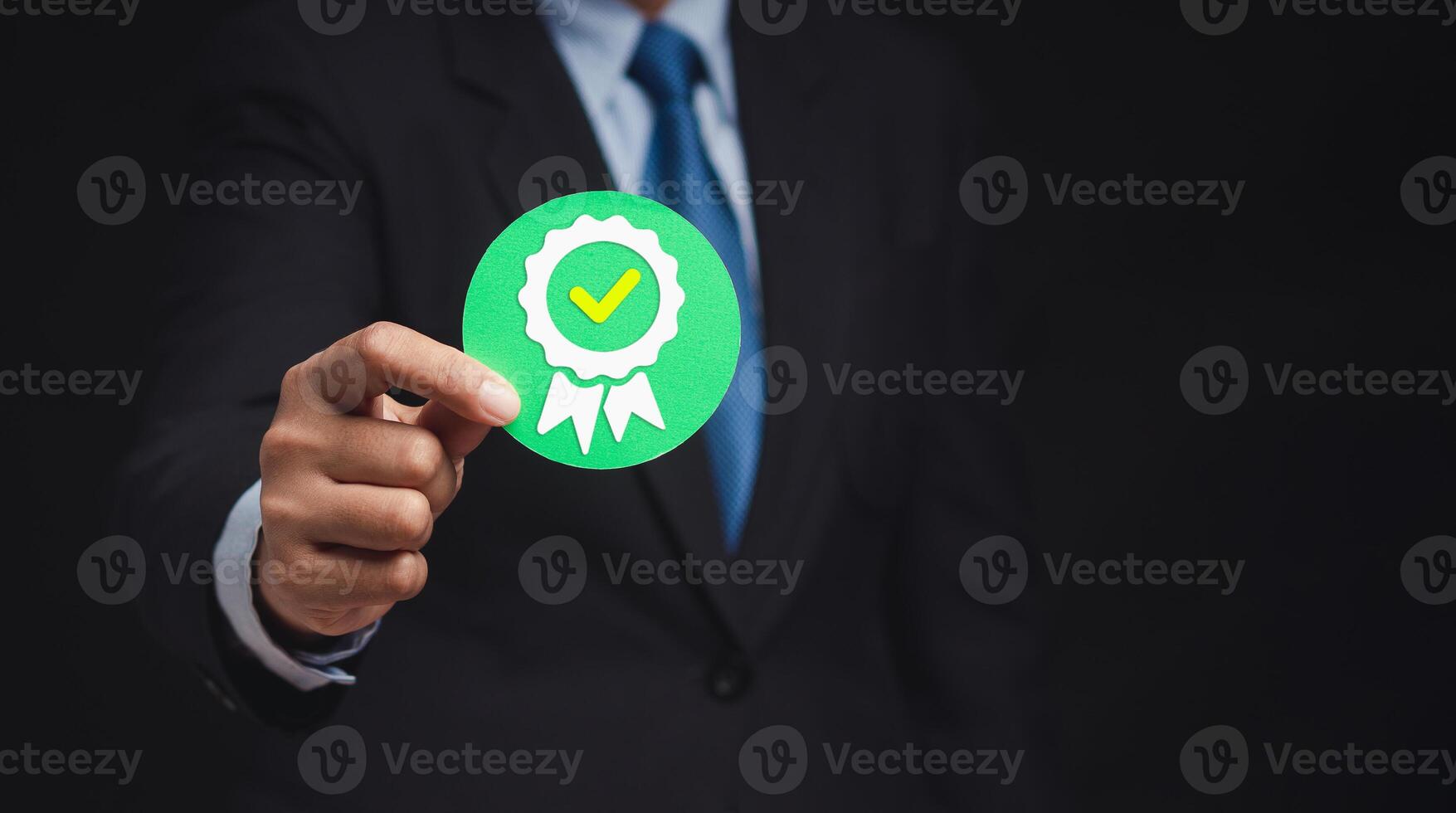 The best quality symbol assurance for a product, service, and ISO certification on a hand businessman photo