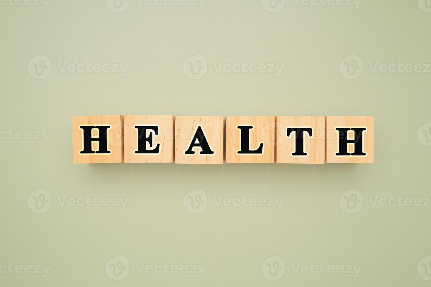 Top view of wooden cubes with words HEALTH on a green background photo