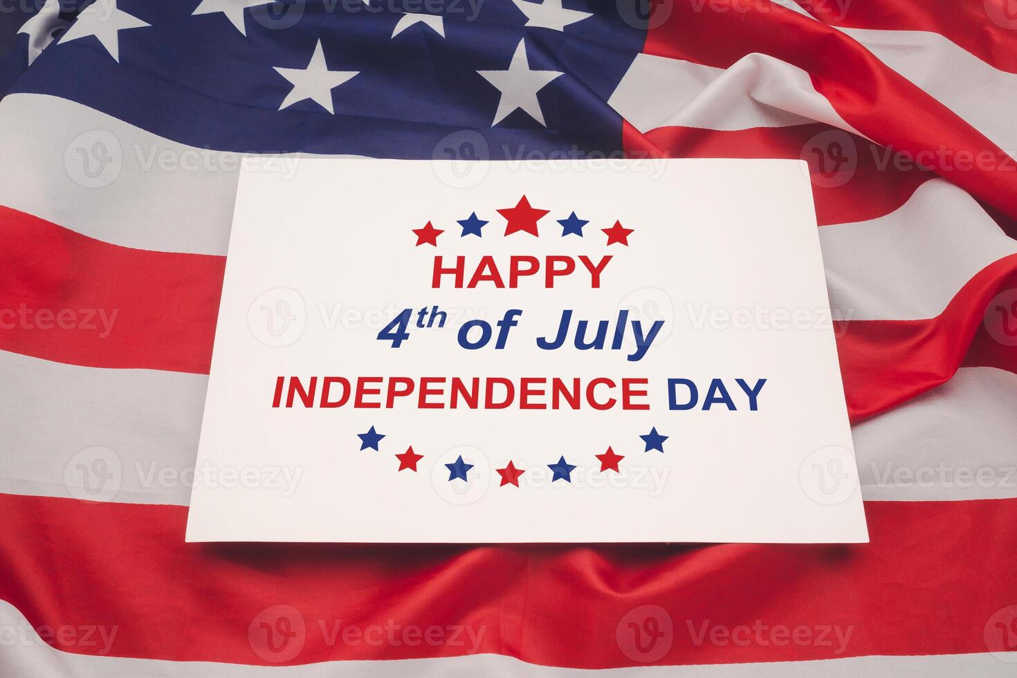 The text of Happy 4th of July Independence day on a white paper over the American flag background photo
