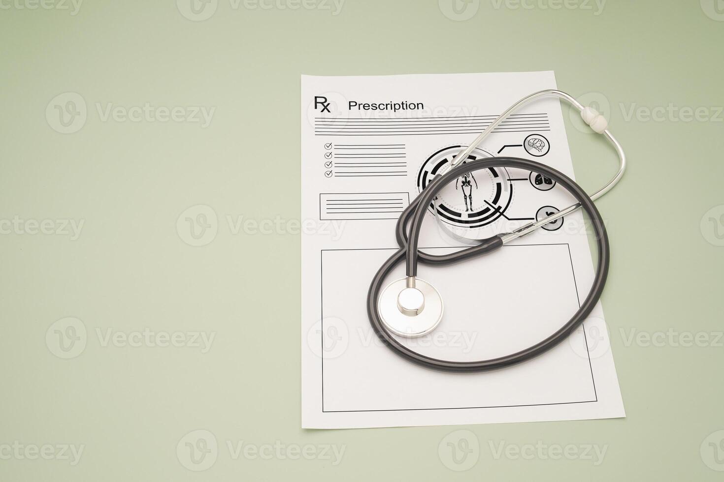 Top view of a stethoscope over the medical prescription sheet on a green background. photo