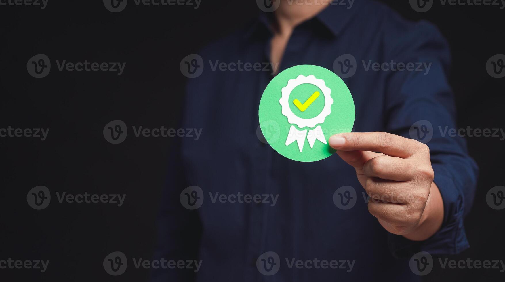 The best quality symbol assurance for a product, service, and ISO certification on a hand businessman. Space for text. photo