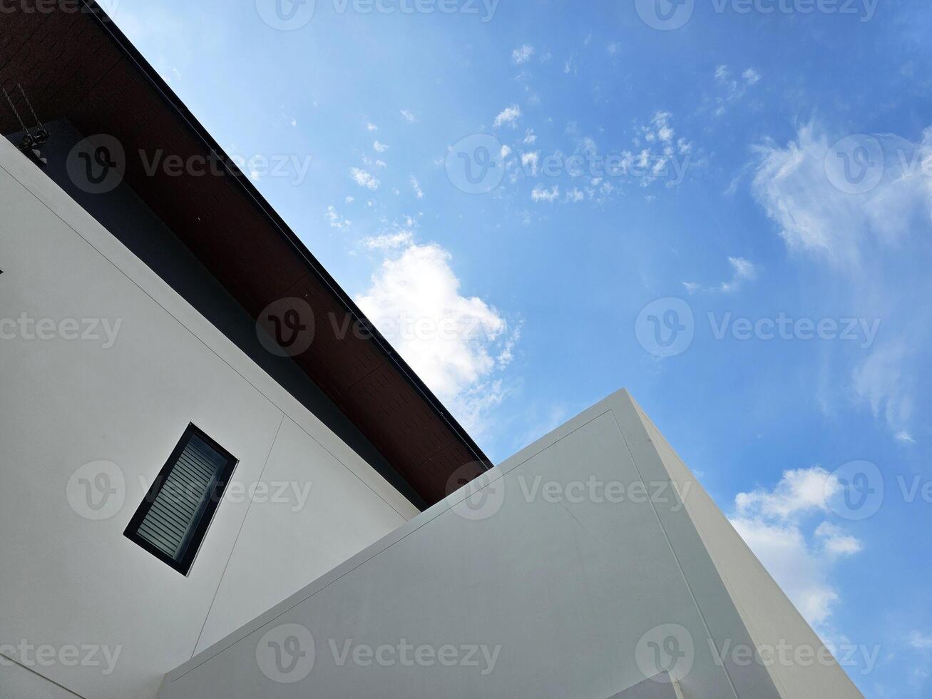 Bottom View of Minimal House with Blue Sky Background. photo