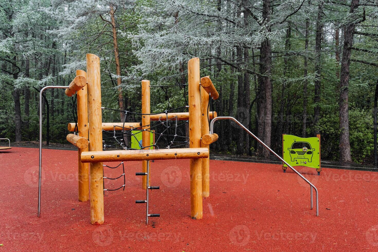 A beautifully crafted wooden playground set is nestled in a vibrant forest, offering families a fantastic spot to enjoy the outdoors and create lasting memories together photo