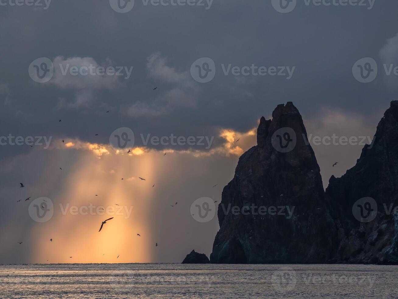 sunset rays through a cloudy dark sky photo